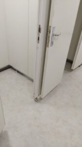 General use bathrooms floor with vinyl tiles & inox skirting board